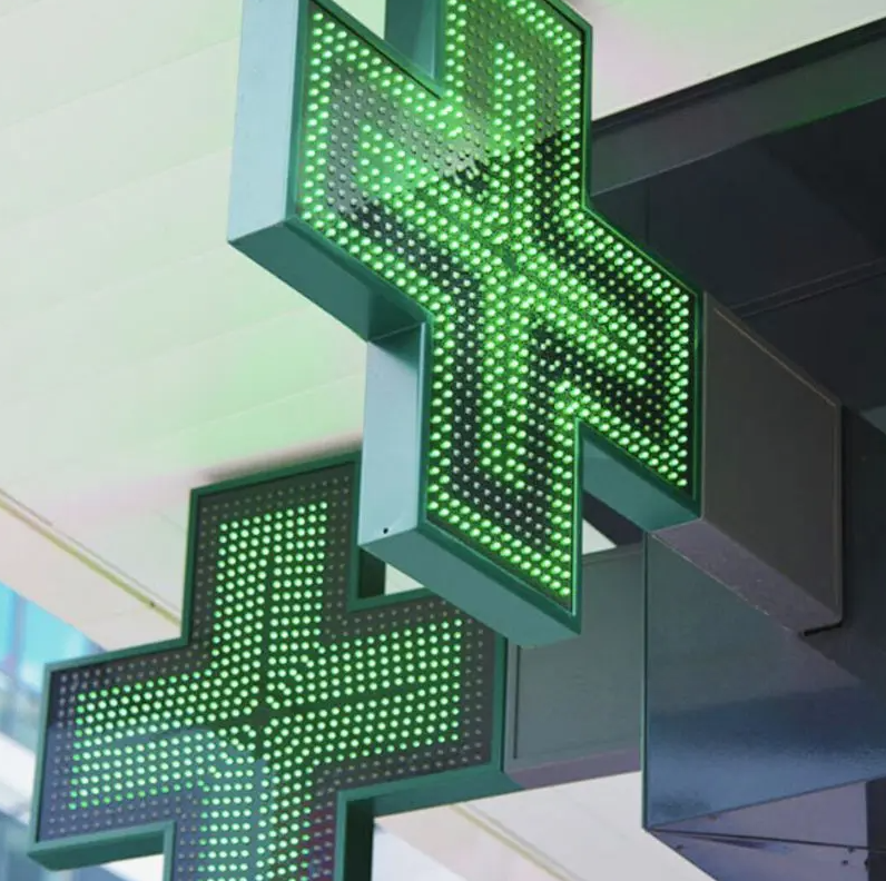 Due croci farmacia LED installate in configurazione doppia sotto tettoia esterna