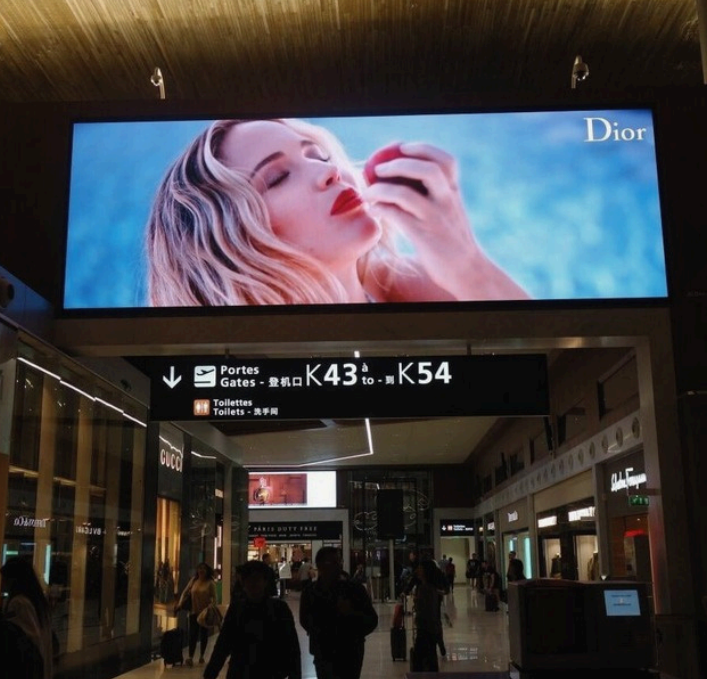 Insegna LED a muro SkySign in aeroporto con campagna pubblicitaria luxury